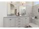 Elegant main bathroom with dual vanity, marble countertops, and walk-in shower at 3940 E Heather Ct, Gilbert, AZ 85234