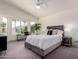 Serene main bedroom with large windows, plush carpet, and neutral color scheme at 3940 E Heather Ct, Gilbert, AZ 85234