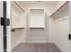 A well organized walk-in closet with shelving, wooden rods, and carpeted flooring at 3940 E Heather Ct, Gilbert, AZ 85234