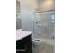 Bathroom featuring a sleek vanity, toilet, and a glass-enclosed shower with shelving at 4924 W Brown St, Glendale, AZ 85302