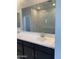 Stylish bathroom featuring a double sink vanity, large mirror, and tiled shower at 4924 W Brown St, Glendale, AZ 85302