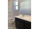 Well-lit bathroom featuring a vanity with double sinks and bathtub with shower at 4924 W Brown St, Glendale, AZ 85302
