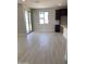 Open dining area with wood-look tile flooring, sliding glass doors, and dark cabinets at 4924 W Brown St, Glendale, AZ 85302