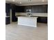 Modern kitchen with dark cabinets, stainless steel appliances, and a large center island at 4924 W Brown St, Glendale, AZ 85302