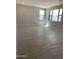 Spacious living room featuring wood-look tile flooring, neutral walls, and natural light at 4924 W Brown St, Glendale, AZ 85302