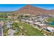 Expansive aerial view showcases a lush golf course, luxurious homes, and desert mountain landscape at 4938 N Ascent Dr, Scottsdale, AZ 85251