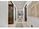 Hallway with light hardwood floors, dark trim and modern art at 4938 N Ascent Dr, Scottsdale, AZ 85251