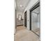 Hallway boasts a modern elevator, light wood floors, and decorative mirror with vanity cabinet at 4938 N Ascent Dr, Scottsdale, AZ 85251