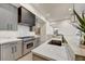 Modern kitchen featuring stainless steel appliances, quartz countertops, and sleek gray cabinetry at 4938 N Ascent Dr, Scottsdale, AZ 85251