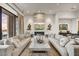 Spacious living room with a fireplace, comfortable seating, and large windows at 4938 N Ascent Dr, Scottsdale, AZ 85251