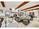 Spacious living room with beamed ceilings, fireplace, and comfortable seating exudes relaxed elegance at 4938 N Ascent Dr, Scottsdale, AZ 85251