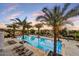 Large community pool surrounded by palm trees and lounge chairs offers resort-style relaxation at 4938 N Ascent Dr, Scottsdale, AZ 85251