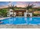 Stunning community pool, palm trees, outdoor seating, and mountain views create an inviting oasis at 4938 N Ascent Dr, Scottsdale, AZ 85251