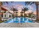 Resort-style pool with palm trees, lounge chairs, and a desert sunset provides the ultimate relaxation at 4938 N Ascent Dr, Scottsdale, AZ 85251