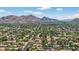 Stunning aerial view showcasing the community with mountain views and lush greenery all around at 5101 E Paradise Dr, Scottsdale, AZ 85254