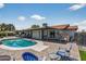 Backyard with a sparkling swimming pool, covered patio, seating, and well-maintained landscaping at 5101 E Paradise Dr, Scottsdale, AZ 85254