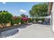 Spacious backyard area with lush landscaping, flowering bushes and a BBQ grill at 5101 E Paradise Dr, Scottsdale, AZ 85254