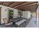 Inviting backyard patio with an outdoor dining table, ceiling fan, and sliding glass doors to the home at 5101 E Paradise Dr, Scottsdale, AZ 85254