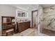 This bathroom has a vanity, a makeup table, and an enclosed shower with striking marble accents at 5101 E Paradise Dr, Scottsdale, AZ 85254