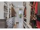 A custom closet system features hanging rods, built in shelving and drawers for storage at 5101 E Paradise Dr, Scottsdale, AZ 85254