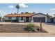 Lovely single-story house boasts a two-car garage, desert landscaping, and a cozy covered porch at 5101 E Paradise Dr, Scottsdale, AZ 85254
