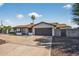 Inviting single-story residence with a two-car garage, desert landscaping, and a covered porch at 5101 E Paradise Dr, Scottsdale, AZ 85254