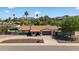 Charming single-story home with a well-maintained front yard, mountain views, and an attached two-car garage at 5101 E Paradise Dr, Scottsdale, AZ 85254