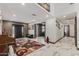 Elegant foyer with marble floors, grey accent brick wall, decorative rug, and plenty of natural light at 5101 E Paradise Dr, Scottsdale, AZ 85254