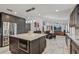 Bright, open kitchen featuring a large island, stainless steel appliances and a seamless flow to dining and living area at 5101 E Paradise Dr, Scottsdale, AZ 85254