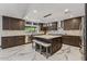Modern kitchen with granite countertops, stainless steel appliances, and large center island with bar stool seating at 5101 E Paradise Dr, Scottsdale, AZ 85254
