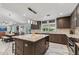 Spacious kitchen with granite island, stainless appliances, lots of cabinet space and a view to the outdoor living at 5101 E Paradise Dr, Scottsdale, AZ 85254