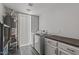This laundry room features a front load washer and dryer and a gray countertop at 5101 E Paradise Dr, Scottsdale, AZ 85254
