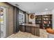Inviting office featuring exposed brick accent wall, large wooden desk, and bookshelf for a functional workspace at 5101 E Paradise Dr, Scottsdale, AZ 85254