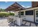 Covered outdoor bar features seating, a mounted TV, and easy access to the home's interior at 5101 E Paradise Dr, Scottsdale, AZ 85254
