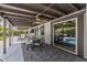 Covered patio boasts a dining area, ceiling fan, and seamless transition to the pool and outdoor bar at 5101 E Paradise Dr, Scottsdale, AZ 85254