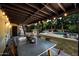 Charming backyard featuring a dining area, covered patio, pool, and lush landscaping at 538 W Las Palmaritas Dr, Phoenix, AZ 85021