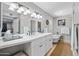Bright bathroom featuring a double vanity, a soaking tub, and elegant fixtures at 538 W Las Palmaritas Dr, Phoenix, AZ 85021