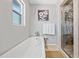 Clean bathroom boasting a freestanding tub, glass-enclosed shower, and neutral finishes at 538 W Las Palmaritas Dr, Phoenix, AZ 85021