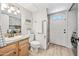 Bright bathroom with granite countertops, modern fixtures, and a convenient door to the exterior at 538 W Las Palmaritas Dr, Phoenix, AZ 85021