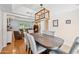 Elegant dining room featuring a wood table, upholstered chairs, and a modern, decorative light fixture at 538 W Las Palmaritas Dr, Phoenix, AZ 85021