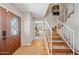 Inviting entryway featuring hardwood floors, a staircase, and a stained glass front door for added charm at 538 W Las Palmaritas Dr, Phoenix, AZ 85021