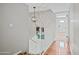 Hallway with hardwood floors, stairs, and access to the front door at 538 W Las Palmaritas Dr, Phoenix, AZ 85021