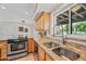 Kitchen featuring stainless steel appliances, wood cabinets, granite countertops, and a double basin sink at 538 W Las Palmaritas Dr, Phoenix, AZ 85021