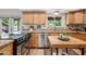 Bright kitchen with wood cabinets, stainless steel appliances, and access to the outdoor patio at 538 W Las Palmaritas Dr, Phoenix, AZ 85021