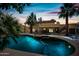 Backyard pool with lush landscaping and a cozy seating area offering a serene outdoor experience at sunset at 538 W Las Palmaritas Dr, Phoenix, AZ 85021