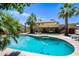 Backyard pool featuring a landscaped yard, palm trees and a cozy outdoor seating area at 538 W Las Palmaritas Dr, Phoenix, AZ 85021
