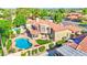 Aerial view of the home featuring a pool, outdoor living spaces, and lush landscaping at 5431 E Piping Rock Rd, Scottsdale, AZ 85254