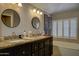 Bright bathroom featuring double sinks, granite countertop, and vanity at 5431 E Piping Rock Rd, Scottsdale, AZ 85254