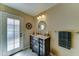 Bathroom featuring vanity with granite countertop, and door to backyard at 5431 E Piping Rock Rd, Scottsdale, AZ 85254