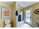 Bathroom featuring toilet, tub-shower combo with glass doors, and door to backyard at 5431 E Piping Rock Rd, Scottsdale, AZ 85254